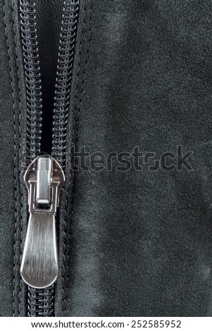 Open zipper on black suede leatherr Closeup of a zipper of a suede leather