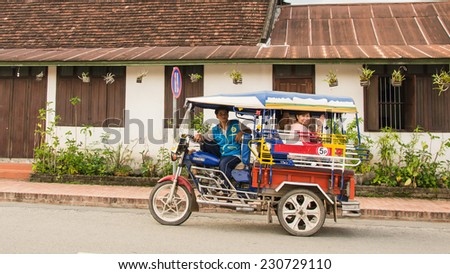 LUANG PRABANG, LAOS - MAY 12: Tuk-Tuk is  available all over town and easy way to get around. Mini van and mini bus can be hired through guesthouses and hotels on May 12, 2014 in Luang Prabang, Laos.