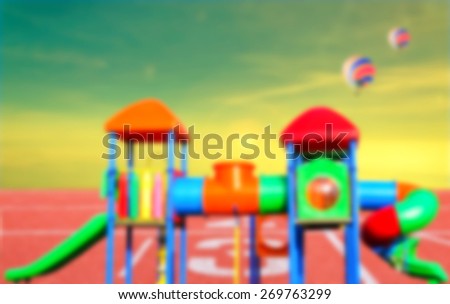 De-focused and blur image of children\'s playground on running track number standard red color with two balloons