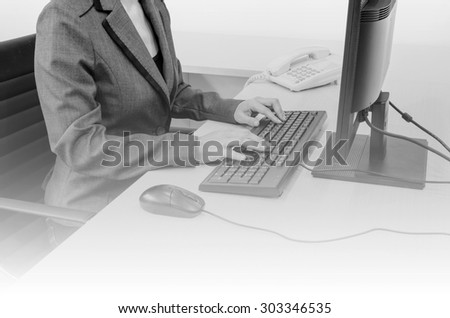 businesswoman with computer in office  - black and white tone