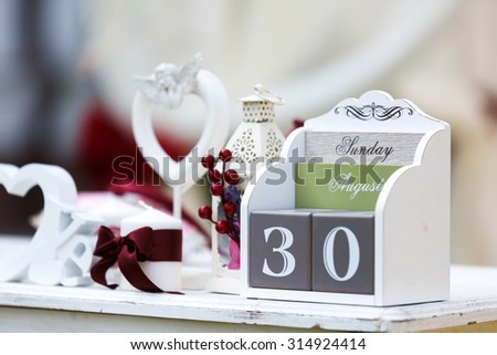 Wedding decor, LOVE letters and flowers on table. Fresh flowers and LOVE decoration on festive table. Luxurious wedding decoration on restaurant table. Elegant event