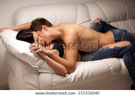 young lovers kissing on the couch