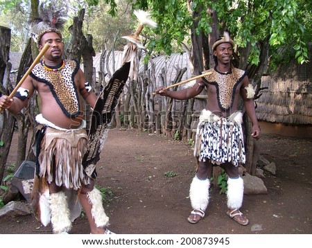 SHAKALAND, SOUTH AFRICA - CIRCA NOVEMBER 2011: Unidentified Zulu men wearing traditional Zulu warrior clothing at Shakaland Zulu Cultural Village, KwaZulu-Natal, South Africa