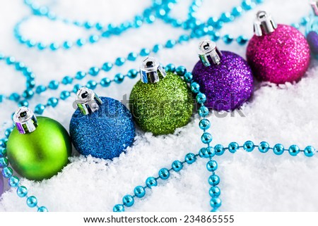 Christmas balls and garland on the snow