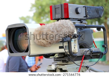 Professional video camera for recording sports programs. On the camera has a large microphone