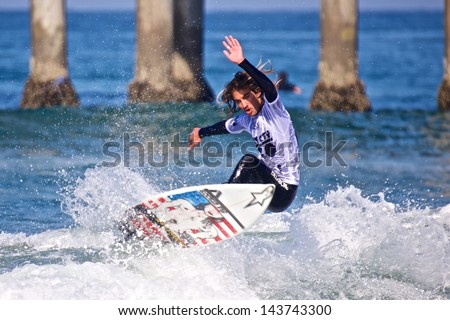 HUNTINGTON BEACH, CA - MAY 25: Pro surfer Aryn Farris catching air in the 2013 American Pro Surfing Series (APPS) at the Huntington Beach Pier.