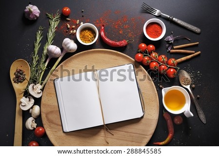 Pizza culinary guide book and ingredients spices pepper tomato oil basis for pizza on a black background