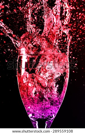 wine glass and splash colored water red