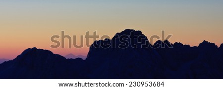 Mountain silhouette in the afterglow. View from the Razor and Stenar from Kredarica in the Julian Alps, Slovenia