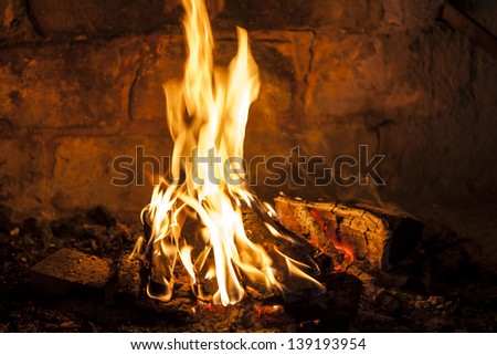 Fireplace with a blazing fire, relaxing view of the fire.