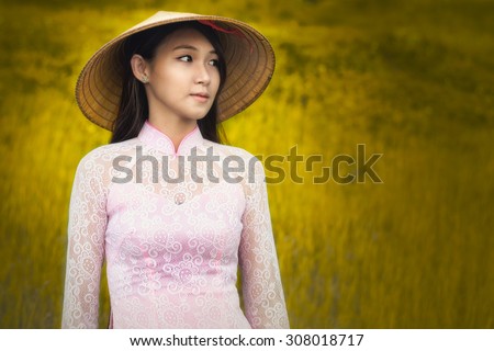 Portrait of Thai girls with Ao Dai, Vietnam traditional dress, Ao dai is famous traditional costume for woman in VIetnam. Grain added