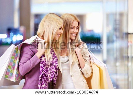 Young women with shopping bags in shop