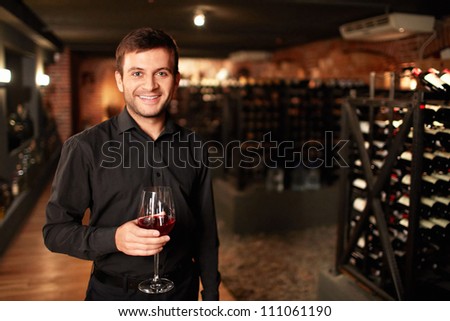 Smiling man in the wine cellar