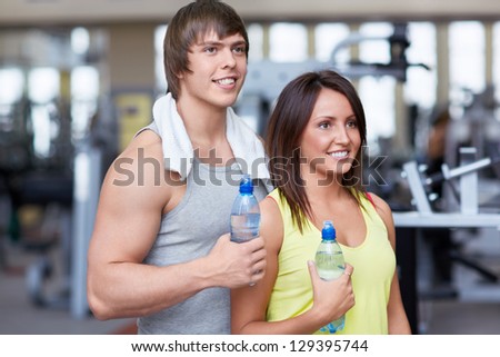 Young people with a bottle of water in fitness club