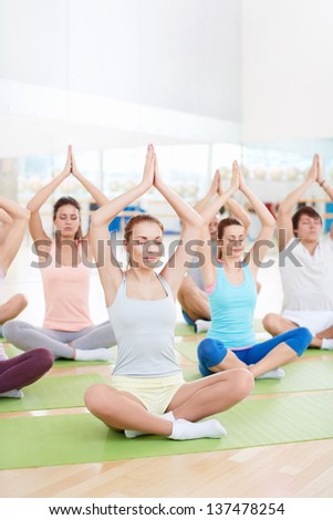 People meditate in a classroom