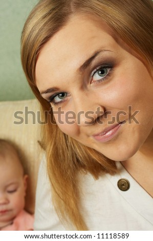 Portrait of the attractive girl with the child on a background