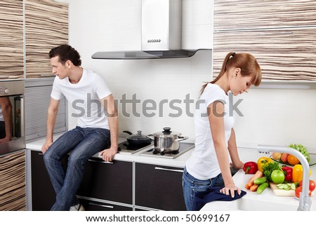 The quarrelled young married couple at kitchen