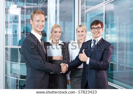 Businessmen shake hands after concluding a successful transaction