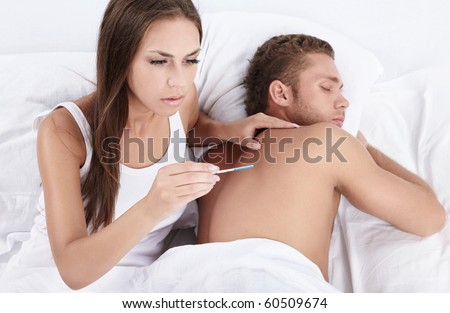 Attractive girl with a pregnancy test a man wakes up