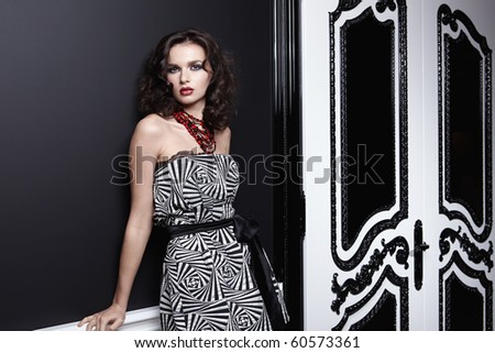 Beautiful girl in a dress on black background