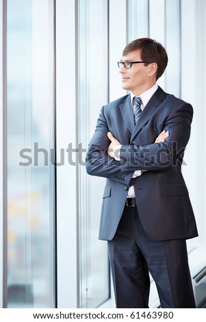 Business man in suit looking out the window