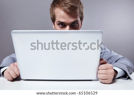 A young man looks out for the laptop