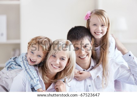 Portrait of a happy family with two children at home
