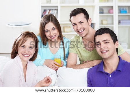 Attractive smiling friends at home