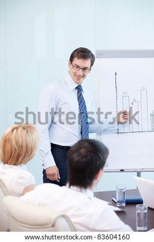 Mature man shows a graph of the staff