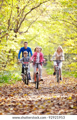Family on bikes in the park