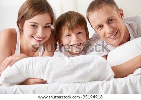 Smiling family in the bedroom