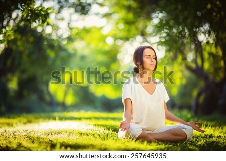 Young girl doing yoga in the park
