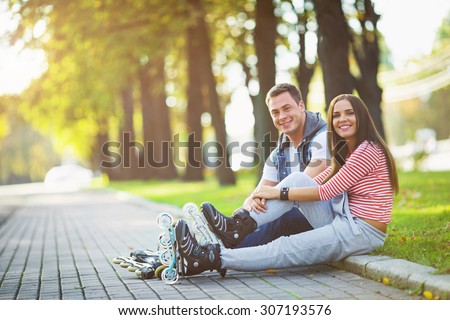 Young couple on roller skates in the park