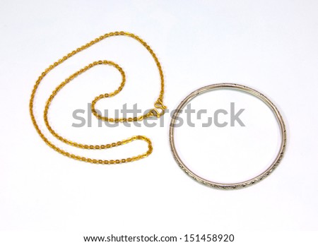 Golden chains and Silver bracelet isolated on white background.