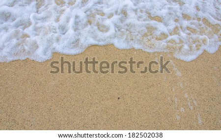 bubble wave of sea on the sandy beach.