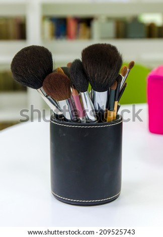 makeup brushes on table.