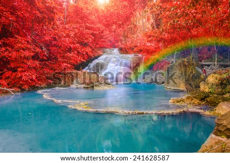 Wonderful Waterfall with rainbows and red leaf in Deep forest at Erawan waterfall National Park, Kanjanaburi Thailand.