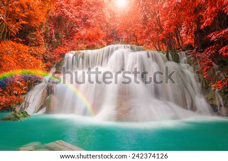 Wonderful Waterfall with rainbows and red leaf in Deep forest at Erawan waterfall National Park, Kanjanaburi Thailand