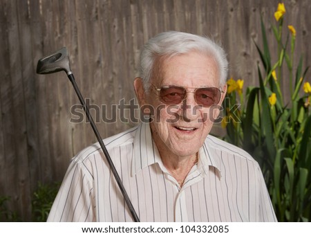 Happy old man senior citizen with golf club