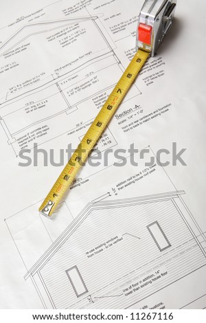 Architecture blueprints of home addition with tape measure