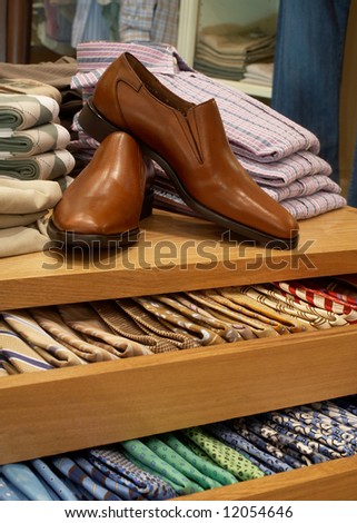 Display of shoes and neckties in modern upscale men\'s clothing store