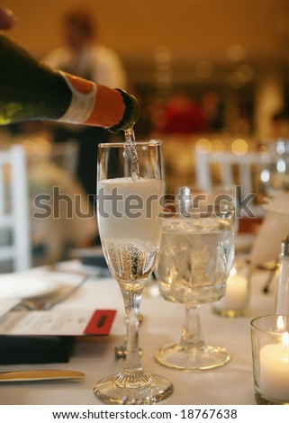 Bottle of champagne poured into a glass
