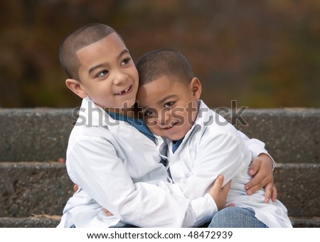 Happy hispanic boy brothers hugging with sibling love