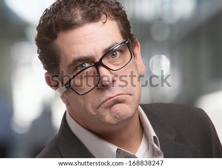 Frowning stressed businessman with funny expression