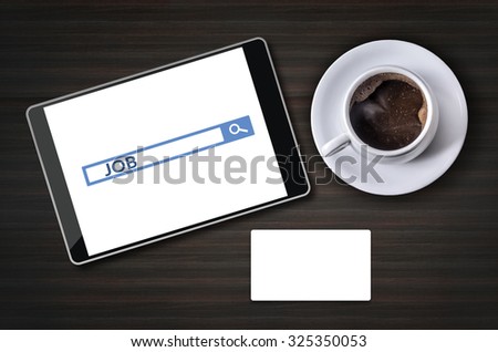 Job search on tablet pc with coffee cup and blank business card on wooden desk. Job search concept.