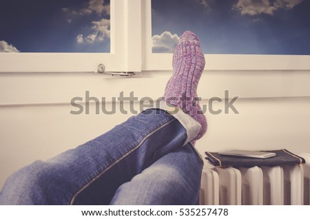 Legs on radiator. Warming by the radiator. ストックフォト © 