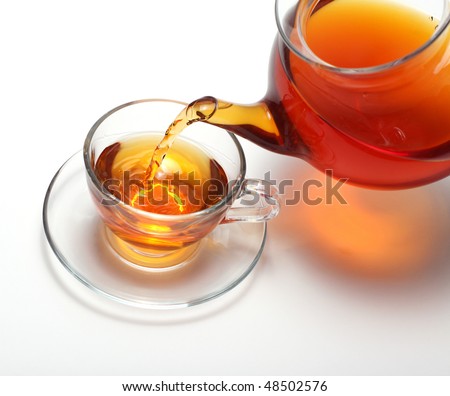Pouring tea to a teacup