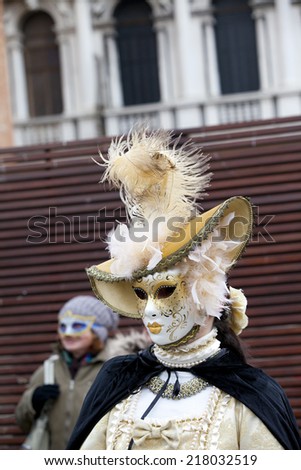 Venice, Italy - February 11 2012: Woman with typical venetian carnival costume at the Carnival of Venice. Shot in St. Mark\'s Square.