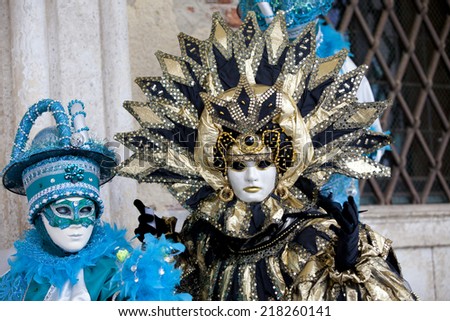 Venice, Italy - February 11 2012: Women with typical venetian carnival costume at the Carnival of Venice. Shot in St. Mark\'s Square..