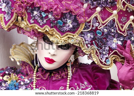 Venice, Italy - February 11 2012: Woman with typical venetian carnival costume at the Carnival of Venice. Shot in St. Mark's Square.